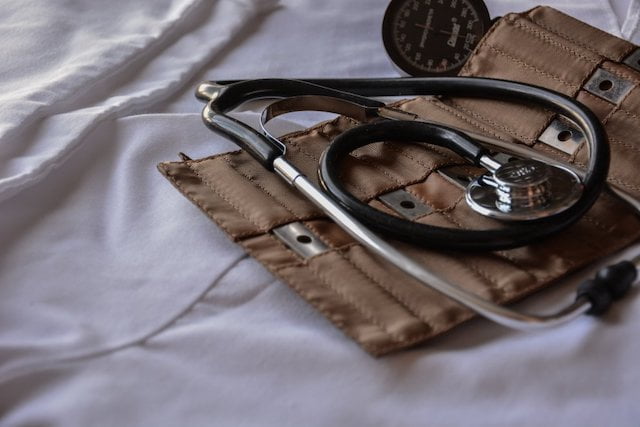 A stethoscope on top of a bed used for patients with mecfs.