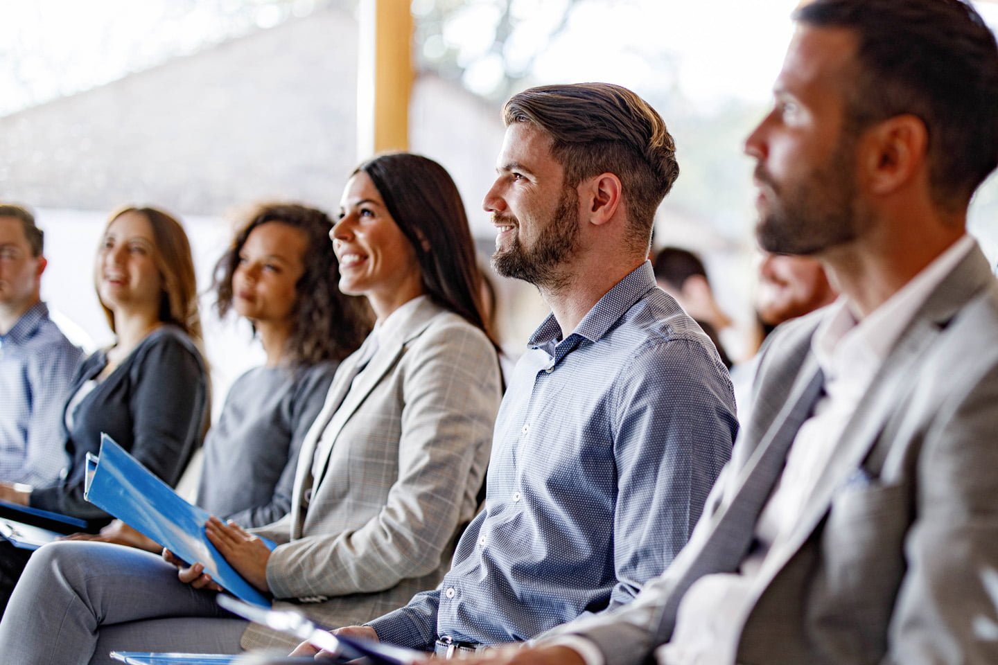 A group of business people listening to a presentation on mecfs.