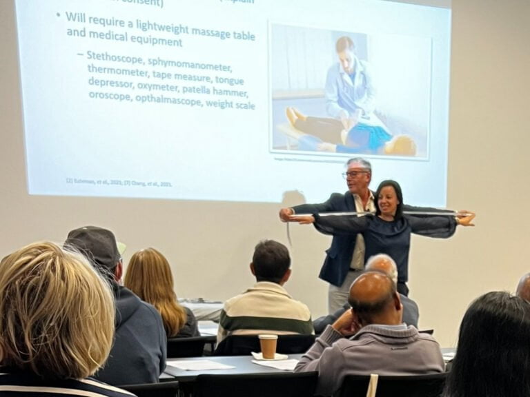 A group of ME/CFS patients standing in front of a projection screen.