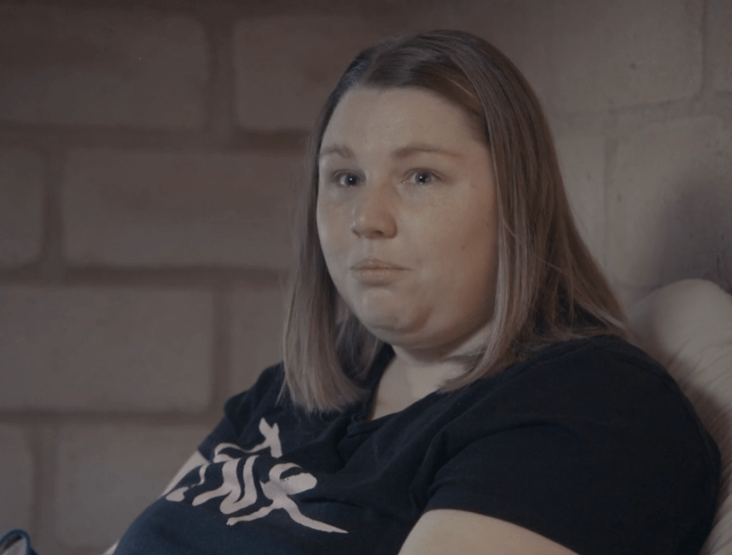 A woman with ME/CFS sitting in a chair.