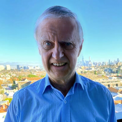 A man with ME/CFS standing in front of a city.