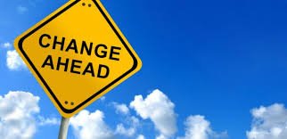A yellow sign with the word change ahead signifies the journey of individuals with ME/CFS towards better health and well-being against a blue sky.